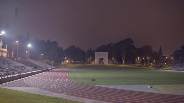 Camera Pans From Left To Right On A Beautiful Empty Track And Field Stadium On A Foggy San Francisco Night 