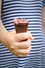 lady hand holding melted chocolate ice cream and missing bite