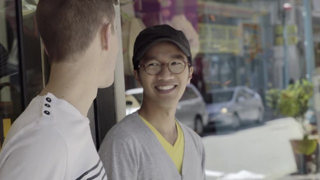 Happy Gay Couple Chat Outside A Shop In Chinatown, San Francisco 