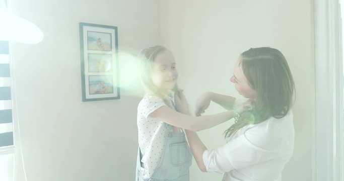 Mother is combing her daughter.