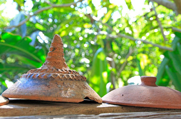 earthenware on old wooden floor is in the garden.
