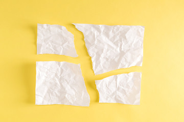 Torn pieces of paper on a yellow background