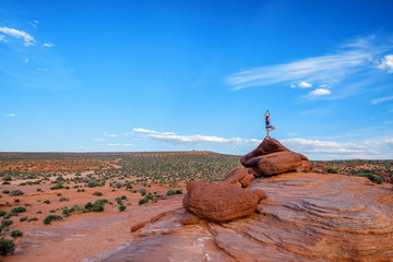 Person Standing Yoga Pose on Top of Rock