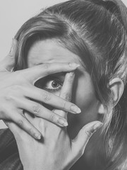 Shy girl hiding her face.