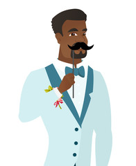 Young african-american groom with a fake mustache.