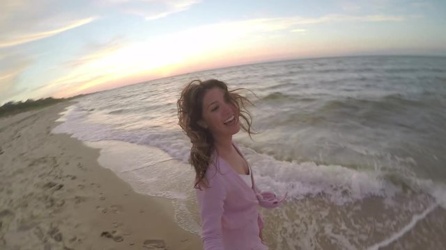 Carefree Young Woman Uses Gopro Stick On Beach, She Spins Around, Smiles