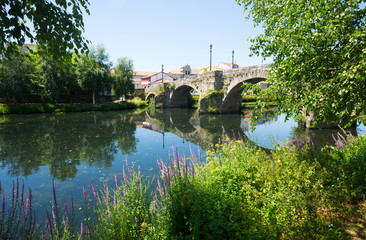 Fototapeta na wymiar river and old stone bridge at Monforte de Lemos