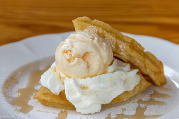 Ice cream with waffles topped with honey