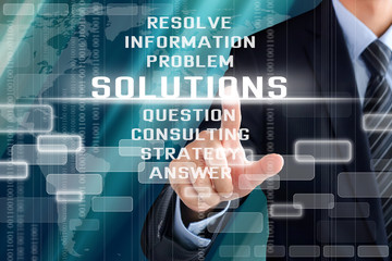 Businessman hand touching SOLUTIONS sign on virtual screen