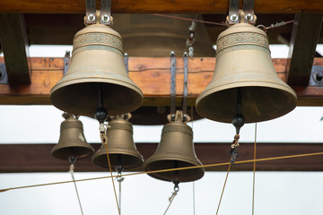 Fototapeta premium New bronze bells on beam in belfry