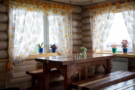 Interior cafe in russian rustic small hut with windows