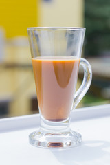 milk coffee in modern glass on white table