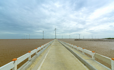 Clean energy, wind power plant with a pathway to the giant wind turbines at sea to provide electricity for human life.
