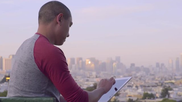 Tourist Uses Tablet To Photograph San Francisco Skyline 
