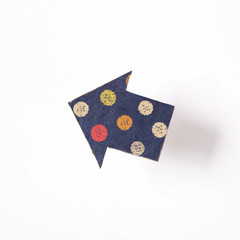 Arrow shaped paper on white background