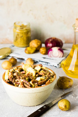 Bavarian salad with smoked meat on a light background