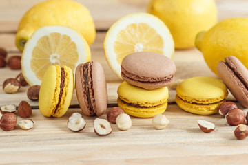 Yellow and brown french macarons with lemon and hazelnuts