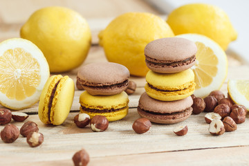 Yellow and brown french macarons with lemon and hazelnuts
