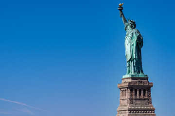 Fototapeta na wymiar Statue of liberty in New York isolated on blue
