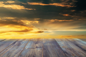 Fototapeta na wymiar Wooden floor and colorful of sky when sunset in the background , blurred effect