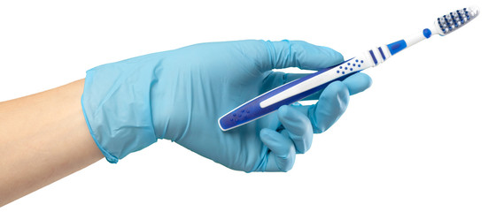 Toothbrush in the gloved hand