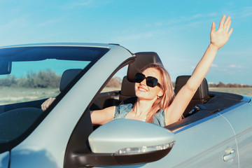 Relaxed happy woman traveling in a car