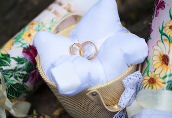 Attributes of the wedding, wedding rings of yellow metal on a white pillow