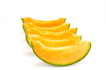 Fototapeta na wymiar Slices of fresh organic melon isolated on white background