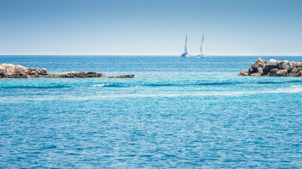 Two sailboats at sea near the island of Paxos, Greece, Europe.