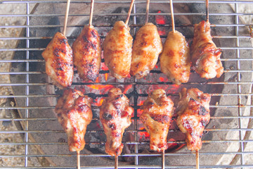 Chicken grilled on charcoal grills