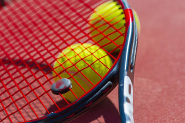 Tennis balls and racket on the grass court