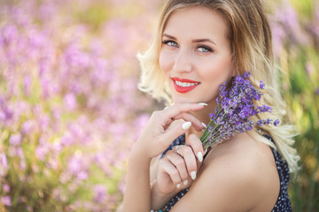 Portrait of beautiful sexy girl sitting in lavender field