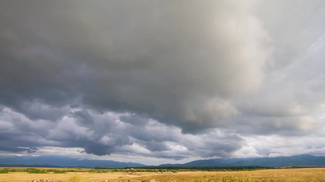 Time lapse of dramatic clouds over a field