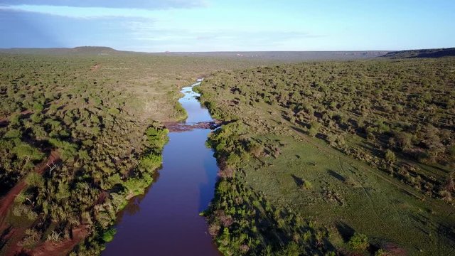 Aerial drone flight over river in uninhabited African nature wilderness