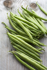 Pile of fresh beans on the wooden background