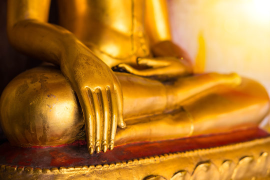 Golden color hand of image of Buddha in old temple of Thailand