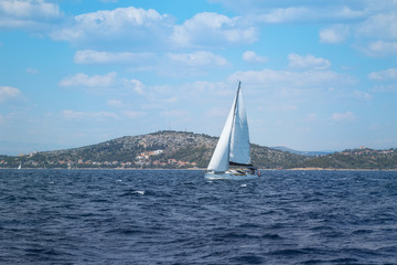 Fototapeta na wymiar Sailboat under Full Sail at Adriatic Sea near the Island of Murter, Dalmatia, Croatia