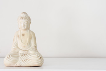 Buddha ornament on white background with copy space for text.