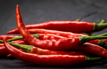 Red chili pepper on nature black stone plate