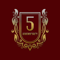 Fifth anniversary vintage logo symbol. Golden emblem with numbers on shield in wreath.