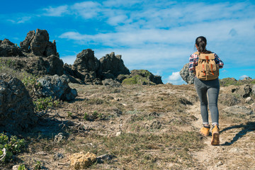 beautiful lady backpacker climbing mountain path