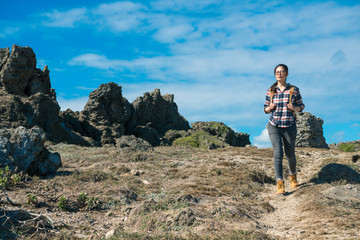 pretty attractive woman hiker walking on rock path