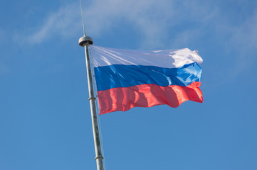 flag of the Russian Federation develops on the flagpole.