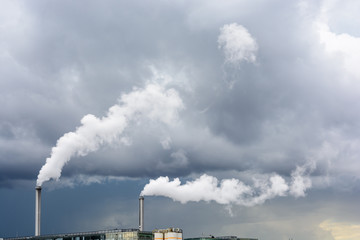 Fototapeta na wymiar Industrial smoke emission from factory chimney under a stormy sky.