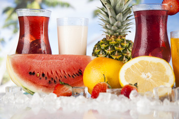 Summer drink, palm branch and Fresh tropical fruits