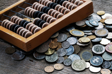 Wooden abacus and a bunch of different coins