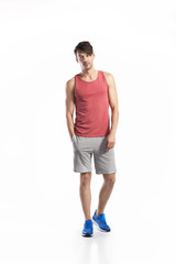 Handsome fitness man in red tank top, studio shot.