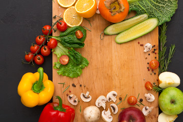 Frame of fresh vegetables on wooden background with copy space