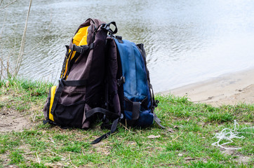Backpacks on a bank of the river