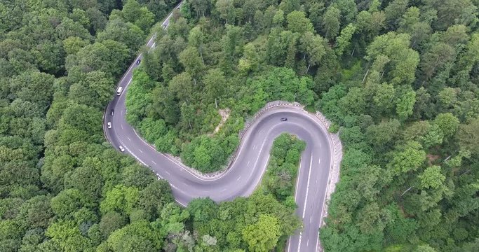 Hairpin turn in the forest. Aerial view from a drone.